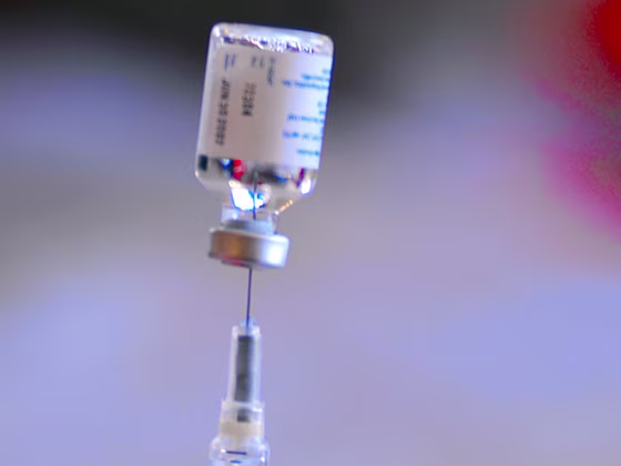 A nurse extracts a flu vaccine from a vial as San Luis Obispo County public healthcare professionals conduct a mass flu vaccination drill at the Veter...